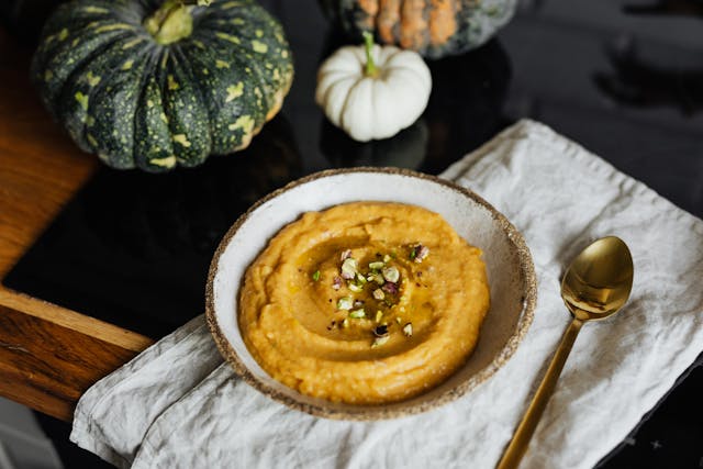 pumpkin soup and pumpkins on a table